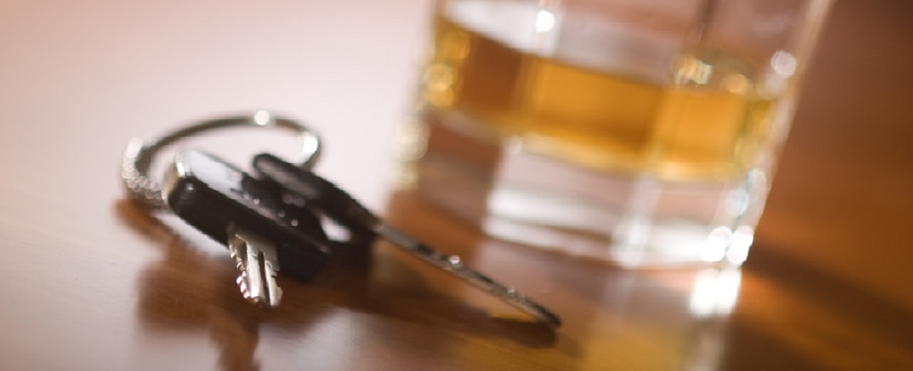 car keys and glass of liquor